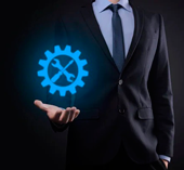 depositphotos_442838164-stock-photo-businessman-holding-gear-icon-tools